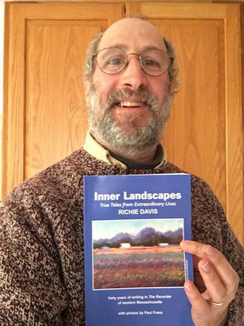 Richie Davis holding his book Inner Landscapes